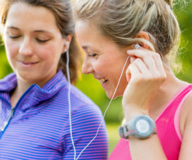 Two women listening to music as they get ready to exercise - Behaviors to beat depression