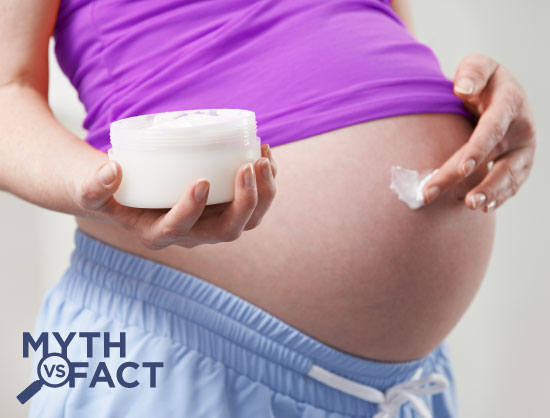 Pregnant woman rubbing lotion on her belly - Pregnancy myths debunked