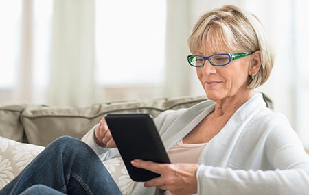 Woman looking at a tablet - Ways to find a doctor