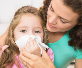 Mom helping daughter blow her nose - Prepping kids for cold and flu season
