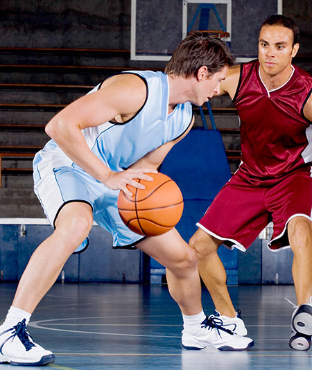 Basketball player dribbling ball - Meniscus repair vs. removal