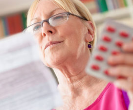Woman reading through medication directions - Prescription intelligence