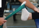 Athlete using four-way band stretching to strengthen her ankle after an injury - PNF exercises