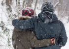 Two people walking in snow - Cancer and cold weather