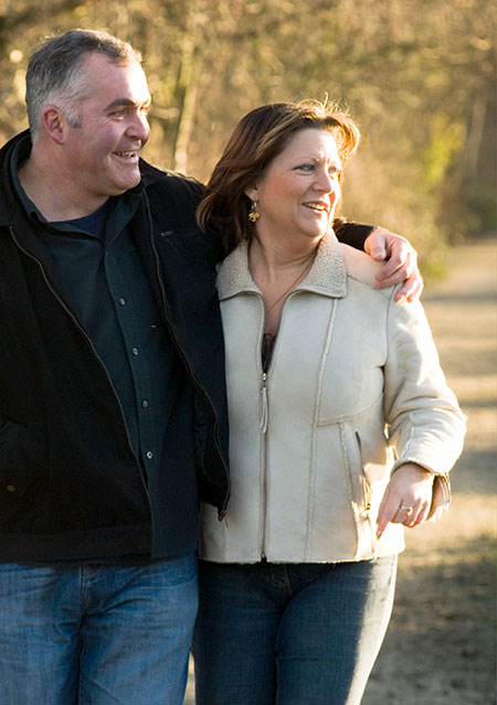 Man and woman enjoying a walk outdoors - What is a herniated disc?