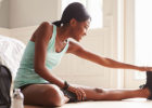 Woman stretching in her home - Early Morning Workouts