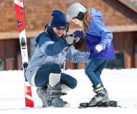 Young girl learning how to ski - Skiing safety