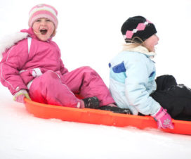 Two kids sledding - Sunburn and snow