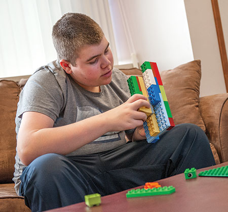 Young boy with BBS playing with legos - Rare diseases - Bardet Biedl Syndrome