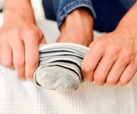 Closeup of person putting sock on foot - Sock marks