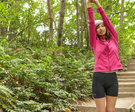Girl stretching in wooded area