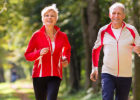 Middle-aged couple walking on wooded trail