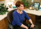 Woman in office chair stretching