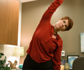 Woman stretching in office