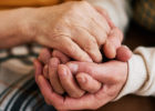 Two elderly holding hands - closeup