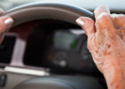 Elderly hands on a steering wheel - Older adults driving safety