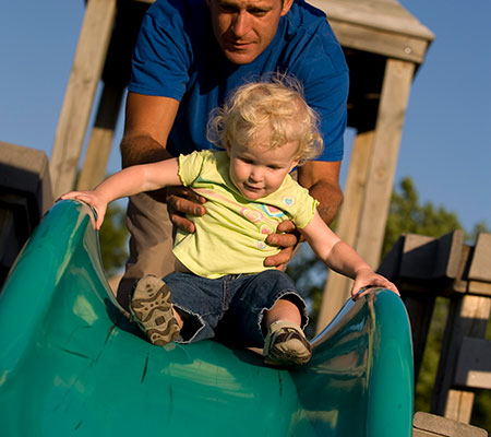 Toddler on slide at playground