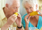 Elderly man and woman eating corn - Can't taste food