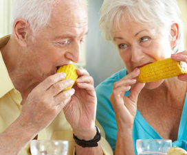 Elderly man and woman eating corn - Can't taste food