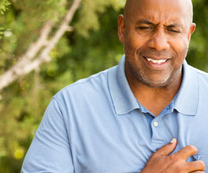 Man holding his chest - Chest pain discomfort