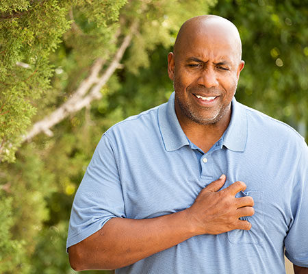 Man holding his chest - Chest pain that isn't a heart attack