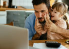 Dad and daughter looking at laptop - Choosing a pediatrician