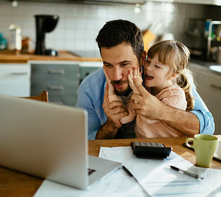 Dad and daughter looking at laptop - Choosing a pediatrician