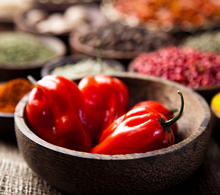 Bowl of red chili peppers and other spices - Are spicy foods good for you?