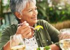 Senior woman eating salad on the patio - Food to reduce joint pain