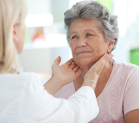 Senior woman getting a throat exam - Thyroid surgery