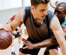 Middle-aged men playing basketball - New exercise program precautions