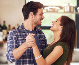 Young couple dancing in the kitchen - Health benefits of dancing
