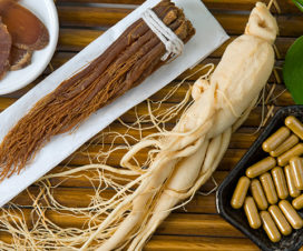Ginseng root, ginseng vitamins and ginseng slices on a bamboo platter - Health benefits of ginseng