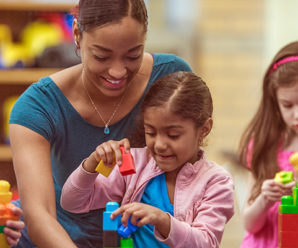 Young children and teacher playing with building blocks - How building toys boost creativity