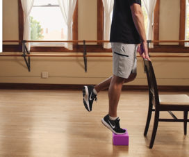 Man exercising with a step stool and chair - Lower body strength video