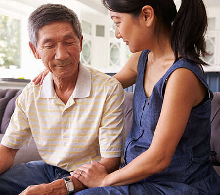 Asian woman consoling a senior man - Pancreatic cancer
