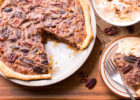Slice of pecan pie taken out of full pie, both pictured - Healthier Pecan Pie Recipe
