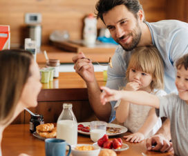 Young family eating breakfast together - Heart health and benefits of breakfast