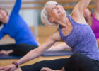 Senior woman stretching at yoga class - Exercises to prevent falls