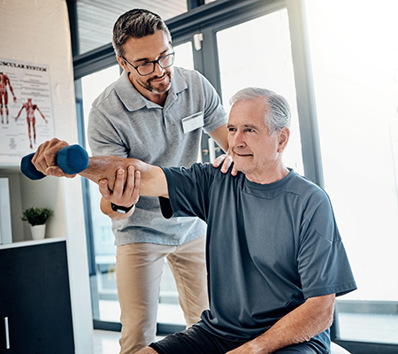 Senior man exercising with a trainer - Coronary microvascular disease