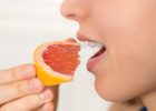 Woman eating a grapefruit - Statins and grapefruit