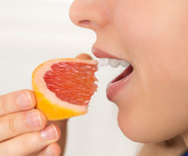 Woman eating a grapefruit - Statins and grapefruit
