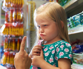 Mother and toddler daughter arguing in a grocery store - Managing temper tantrums