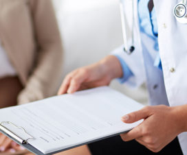 Doctor with a clipboard, meeting with a patient - Alcohol and substance use screening