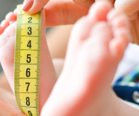 Nurse measuring a baby's foot - What do growth charts mean?