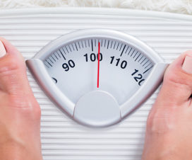 Person standing on a scale - Risks of being underweight