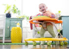 Happy baby rolling around in a baby walker - Are baby walkers safe?