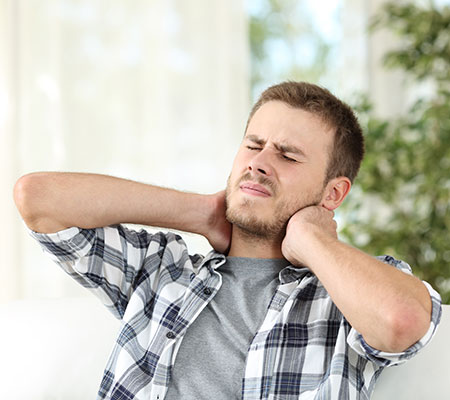 Man massaging a sore neck - Fibromyalgia