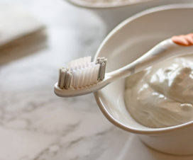 Bowl of homemade toothpaste and a toothbrush - Dental trend: Homemade toothpaste