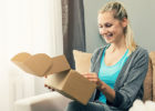 Woman opening a package on the couch - At-home genetic testing